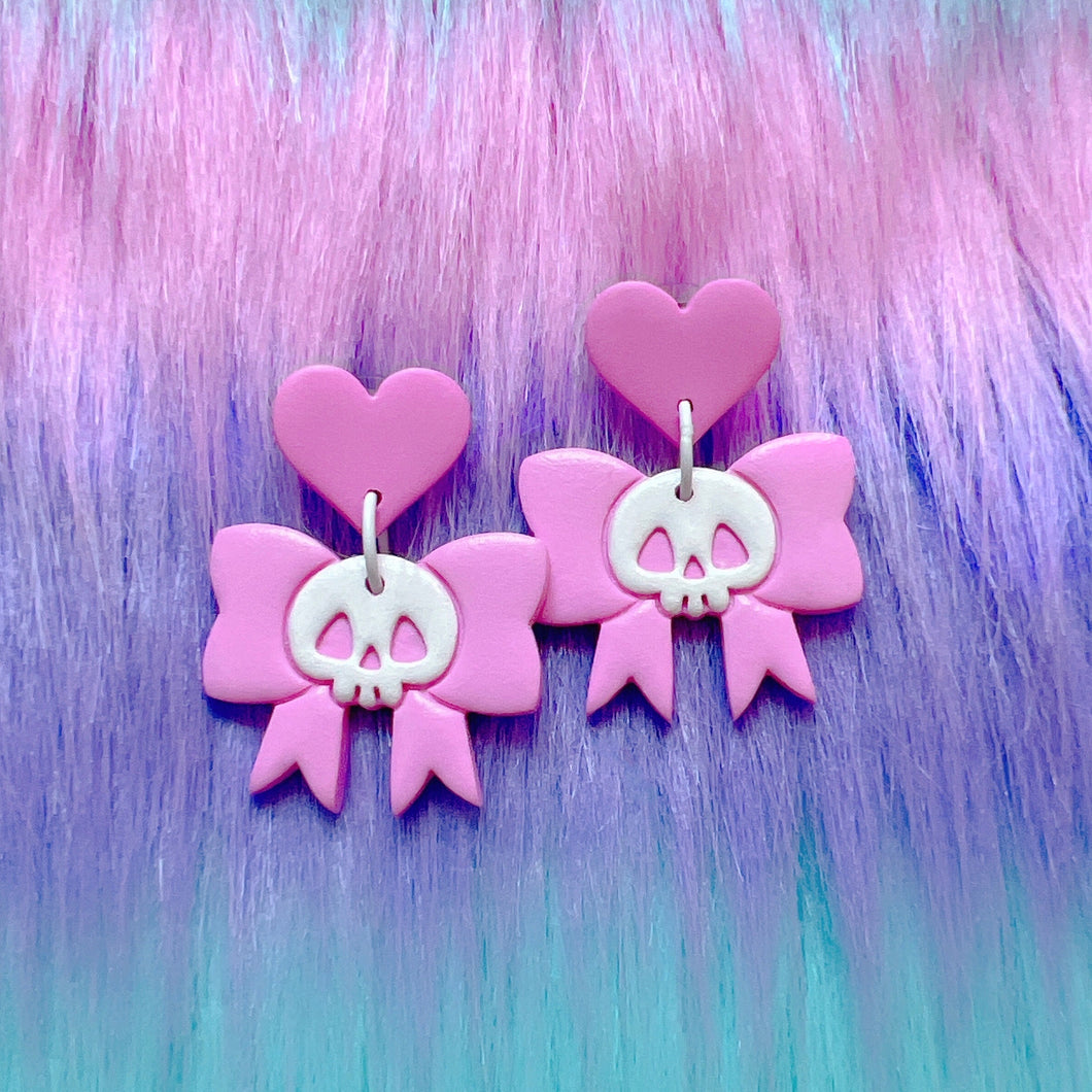 Pink and white skull bow stud earrings