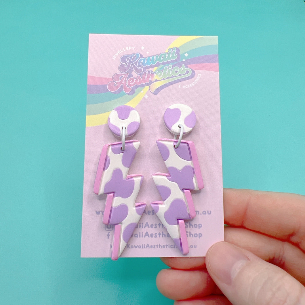 Purple and white cow print polymer clay lightning stud earrings