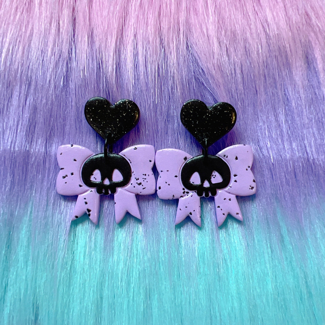 Purple and black skull bow stud earrings